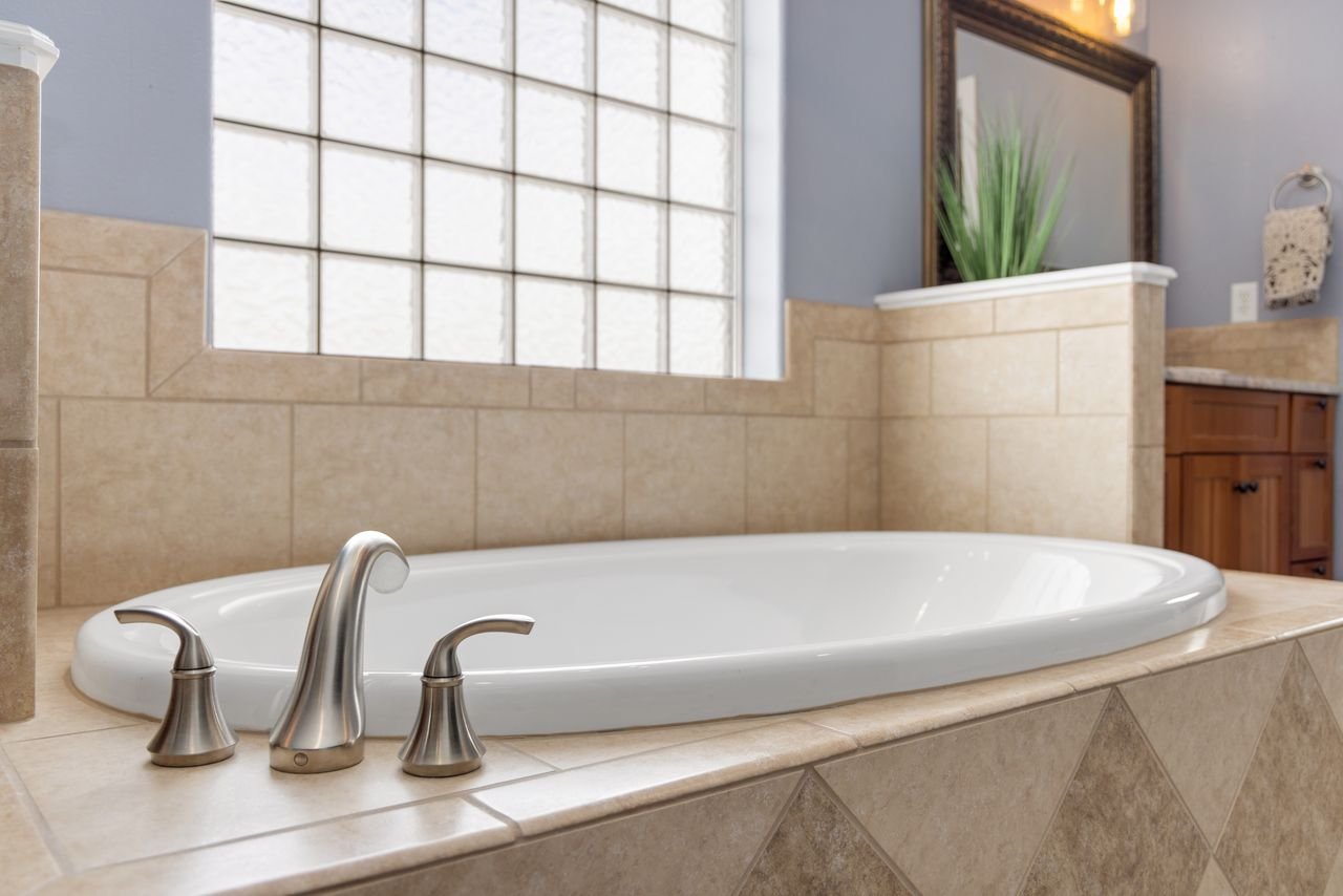 Luxurious modern bathroom showcasing an elegant bathtub with stylish faucet.